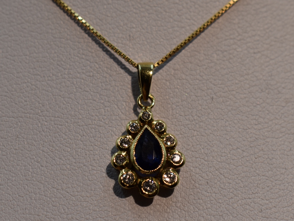 A sapphire and diamond teardrop cluster pendant in a yellow metal mount, marks worn, probably 18ct