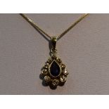 A sapphire and diamond teardrop cluster pendant in a yellow metal mount, marks worn, probably 18ct