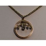 An Edwardian yellow metal pendant stamped 9ct of circular form having seed pearl decoration with