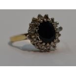 A lady's dress ring having a sapphire and diamond oval cluster having brilliant cut and baguette cut