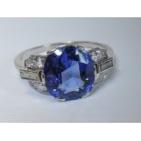 A lady's 1950's dress ring having a large central sapphire, approx 4ct in a six claw setting flanked