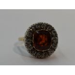 A lady's dress ring having a diamond and spinel style stone cluster, diamonds total approx 0.7ct, in