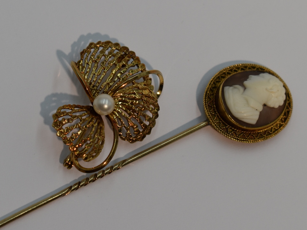 A 9ct gold brooch of stylised floral form having central cultured pearl, and a conch shell cameo pin