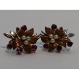 A pair of 9ct white and yellow gold stud earrings modelled as leaves having ruby and seed pearl