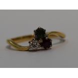 A lady's dress ring having a diamond,emerald and ruby trio, each stone approx 0.125ct in claw set