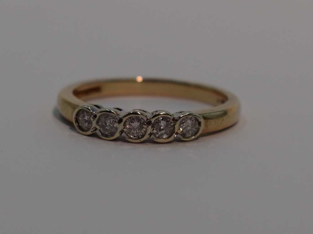 A lady's dress ring having five graduated diamonds, total approx 0.25ct in collared mounts on a