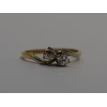 A lady's dress ring having a duo of diamonds, total approx 0.5ct in claw set mount, to cross over