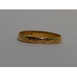 A 22ct gold wedding band having engraved scroll decoration, size V & 3.2g