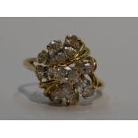 A lady's dress ring having a ten stone cubic zirconia open cluster in a stylised mount on a 14ct