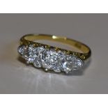 A Victorian lady's dress ring having three graduated diamonds with a border of six diamond chips,