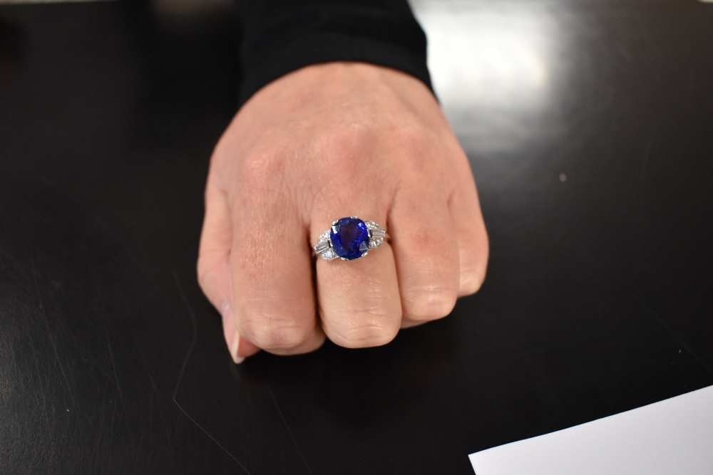 A lady's 1950's dress ring having a large central sapphire, approx 4ct in a six claw setting flanked - Image 4 of 4