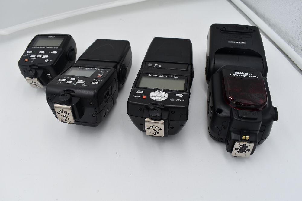 Four Nikon Speedlight flashguns in a hard Peli 1600 case. A Nikon Speedlight SB-900, a Nikon