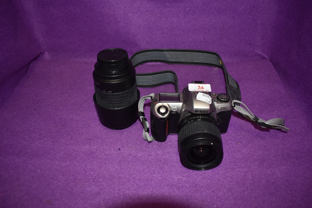 A Nikon F65 camera with an AF Nikkor 28-80mm lens ad a AF Nikkor 70-300mm lens.