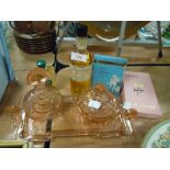 An unusual small art deco glass dressing table set in blush pink, three vintage perfumes/Eau De