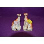 Two small vintage Staffordshire dogs, fashioned as greyhounds or similar.