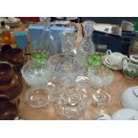 A selection of clear cut and crystal glass wares including green sundae dishes