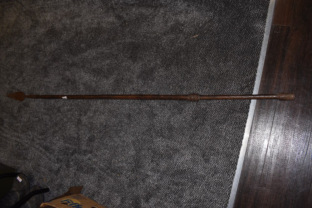 A tribal spear having solid wood shaft with wrought iron head and guards measuring 180cm long