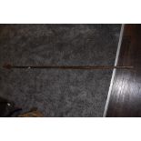 A tribal spear having solid wood shaft with wrought iron head and guards measuring 180cm long