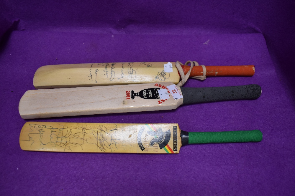 Three miniature cricket bats two bearing signatures one dated 1998 and similar