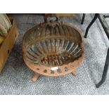 A vintage cast iron oyster design fire grate or grill insert for inglenook or similar