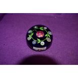 A vintage paperweight having flowers to centre, thought to be Perthshire underside number appears to
