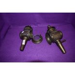 Two Victorian brass carbide lamps having bevelled glass windows and hinged fronts.