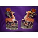 A pair of antique spill vases both in the form of tree stumps,one having deer and fawn the other