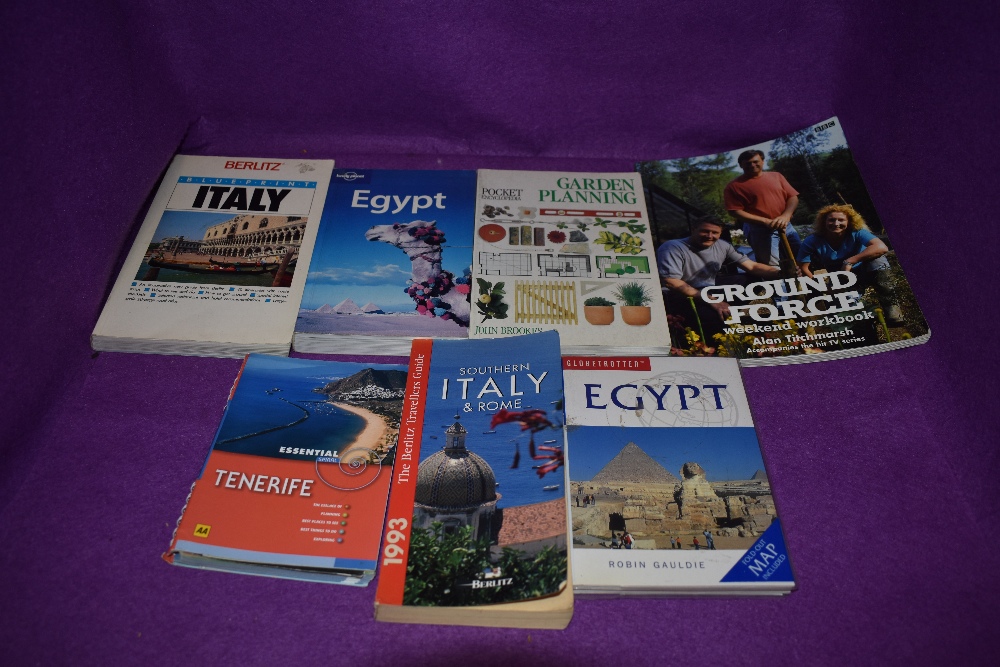 An assortment of Travel guides and gardening books.