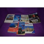 An assortment of Travel guides and gardening books.