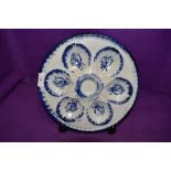 An early 20th century oyster dish in blue and white with rose pattern, marked to back Ironstone,