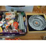 A biscuit tin containing collectable key rings,badges and more.
