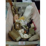 A vintage basket with lid containing an assortment of vintage and antique haberdashery including