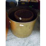 A large brass effect style coal bucket and similar wicker basket