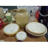 A selection of cream ware kitchen bowls and similar butter dishes also large Hillstonia jug