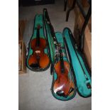 Two student violins and cases`