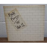 A copy of the Wall by Pink Floyd with inners and stickered sleeve