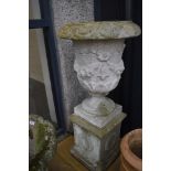 A large concrete garden urn on plinth, overall height approx. 100cm