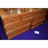 A vintage teak effect low chest of three over two over two drawers, dimensions approx. W150cm