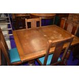 An early to mid 20th Century oak drawer leaf table and four chairs