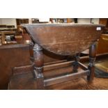 A traditional oak drop leaf twist top occasional table, width approx. 61cm