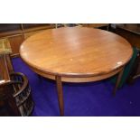 A vintage teak circular extending dining table, G Plan, diameter approx. 122cm