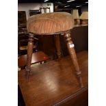 A 19th Century stained frame piano or similar stool on triple splay turned legs
