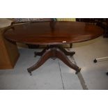 A late 19th century mahogany composite dining table having oval top on bulbous column and