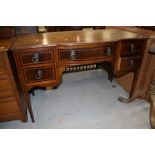 An early 20th Century mahogany and inlaid desk/dressing table , semi bow front , approx. width