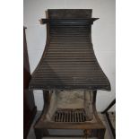 A vintage cast iron open fire place with integral hood