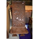 A tribal art carved ethnic palaver chair, depicting hunting scene