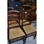 A set of four vintage stained frame ladder back chairs