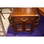 An Oriental hardwood cabinet , having side racks and glazed front, on casters