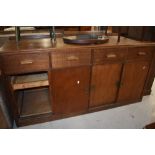 A vintage oak shop or office counter, having four frieze drawers over cupboard base having sliding