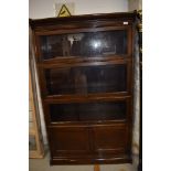 A Globe Wernicke style sectional bookcase of four tiers including cupboard base , width approx. 87cm